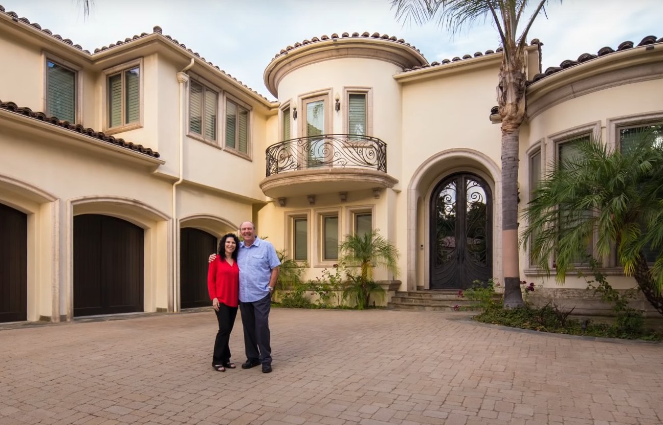 Radio talk show host Bill Handel and his wife in front of their home.