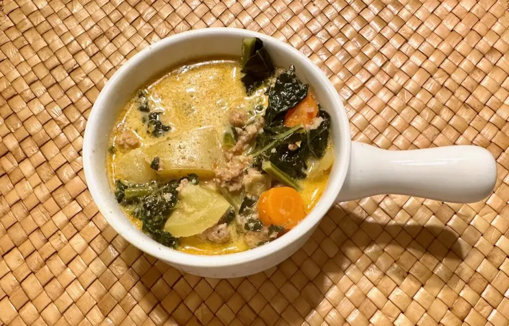 Bowl of kale, potato, sausage soup.