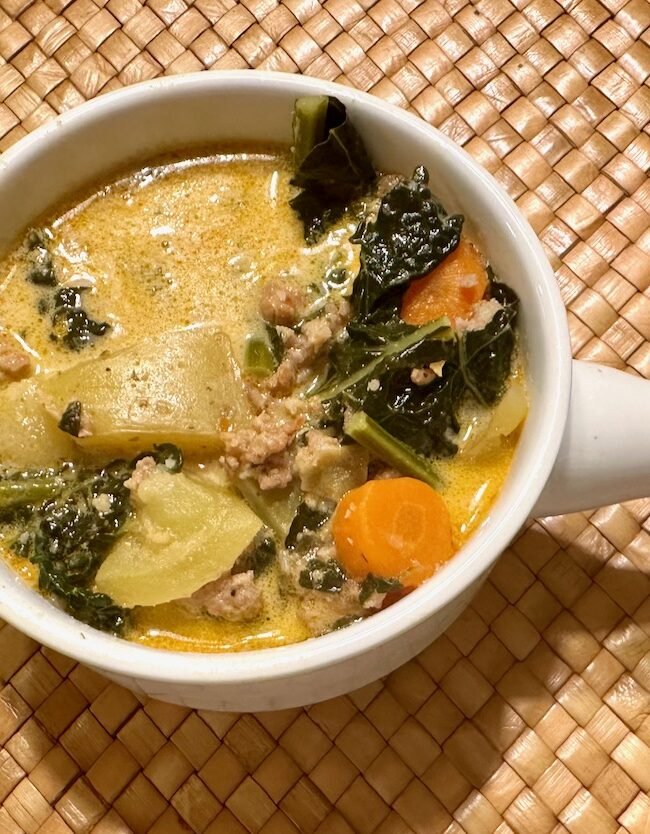 Bowl of kale, potato, sausage soup.