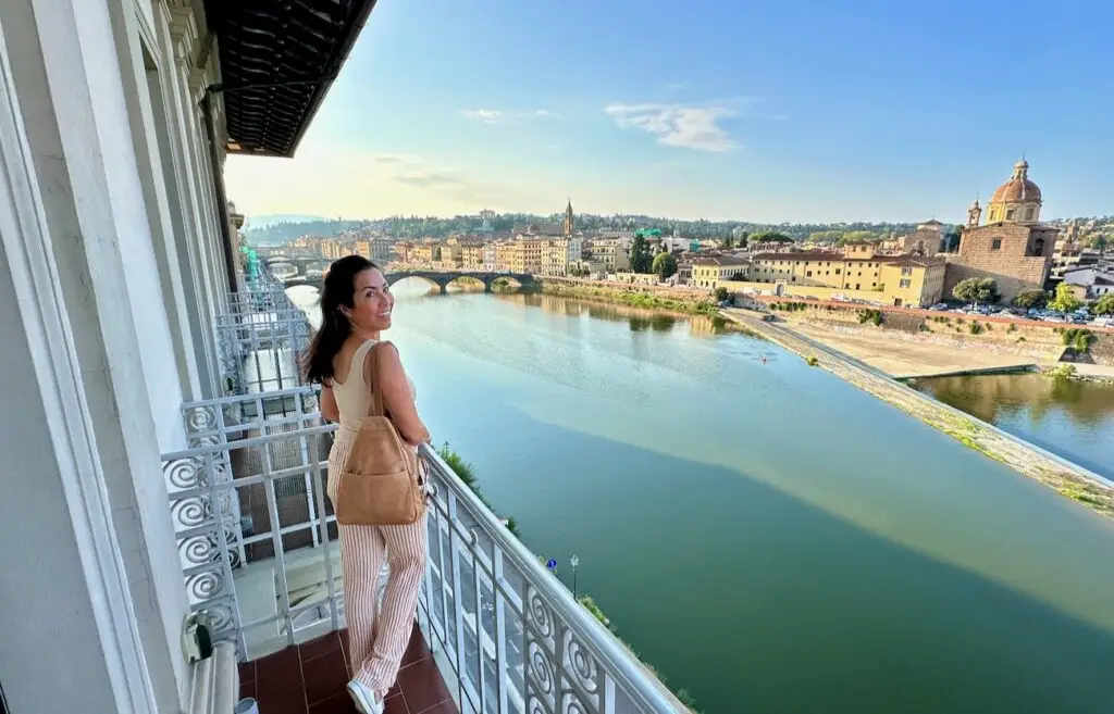 Phoebe Chongchua on the balcony at St. Regis Florence with view of Arno.