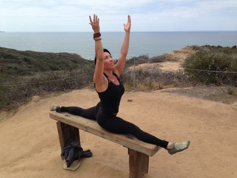 Phoebe Chongchua doing splits on a bench at Torrey Pines