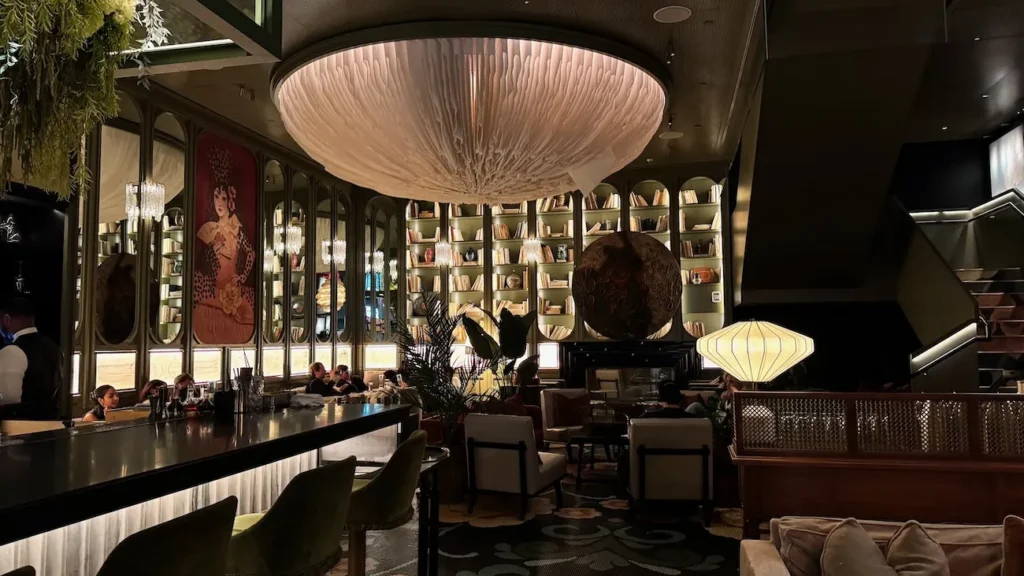 Parlour interior at Bazaar Meats by José Andrés in New York City with sculptural lighting and curated bookshelves