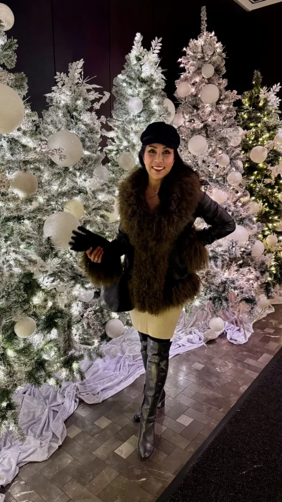 Phoebe Chongchua standing among holiday decorations at The Ritz-Carlton NoMad in New York City
