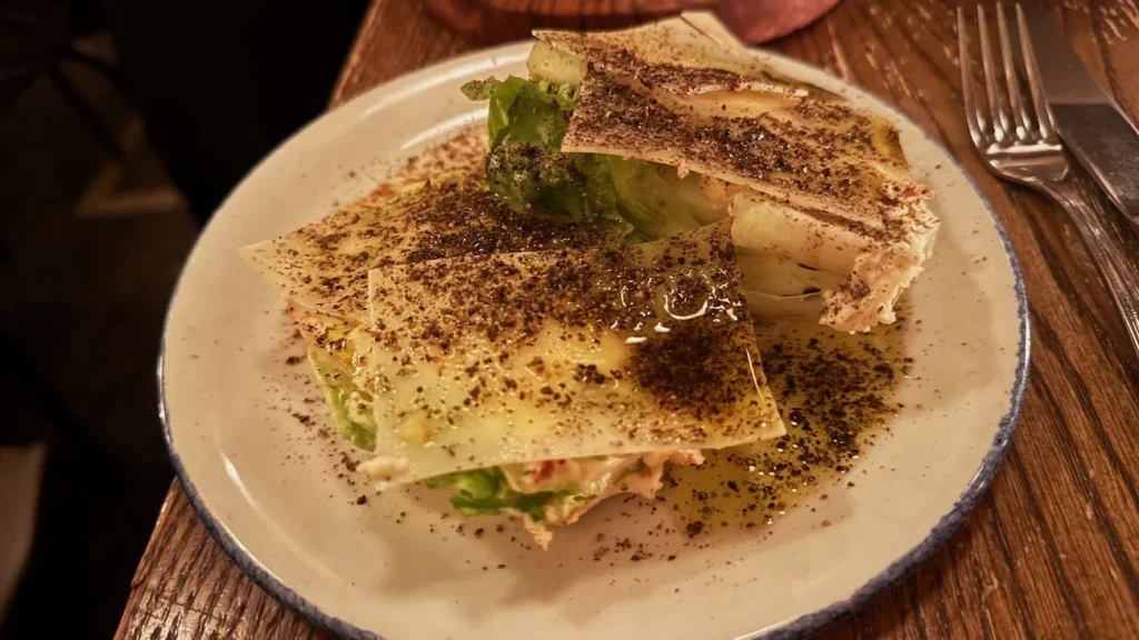 Cacio e pepe in Emilia with lettuce and shaved cheese at Rezdôra in New York City