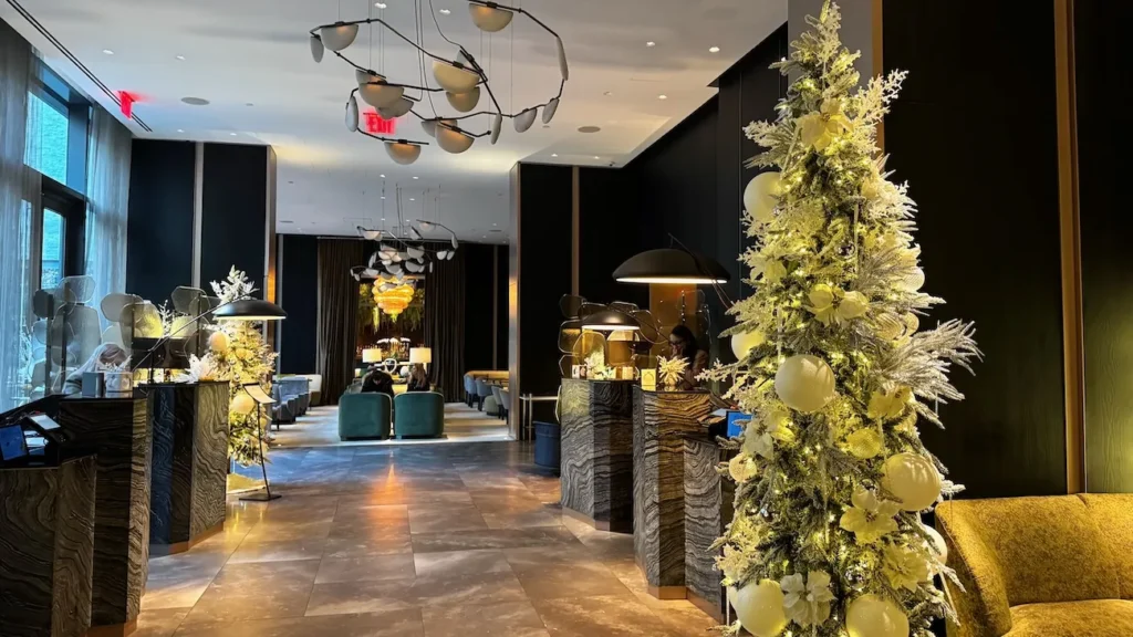 Holiday-decorated lobby with illuminated Christmas trees at The Ritz-Carlton NoMad in New York City
