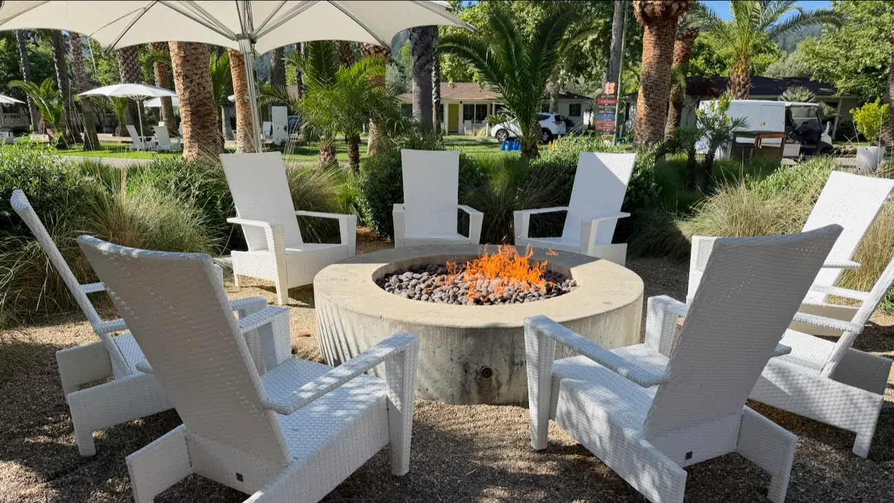 Outdoor fire pit seating area between the mineral pools at Indian Springs Calistoga.