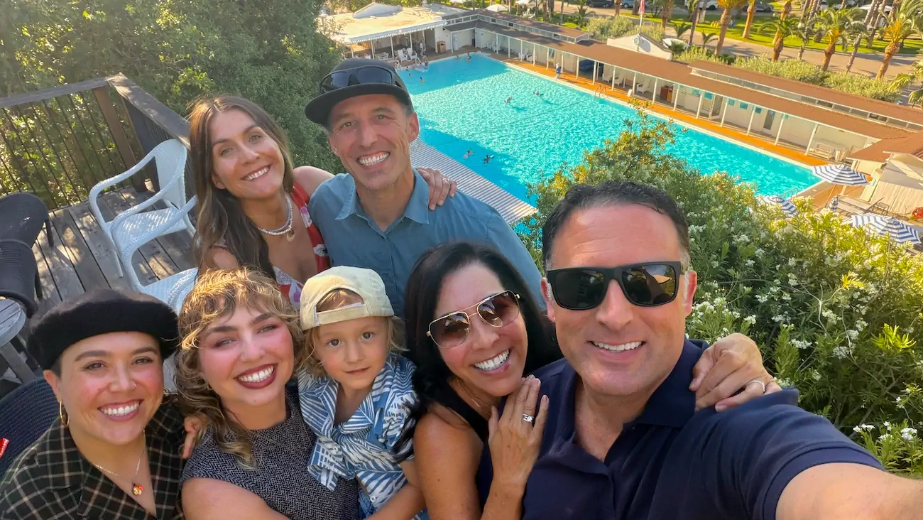 Family gathered on the deck of Hill House overlooking the mineral pool at Indian Springs Calistoga.