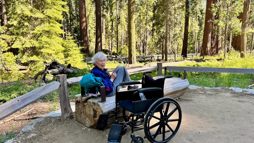Elderly woman enjoying Mariposa Grove in Yosemite National Park.
