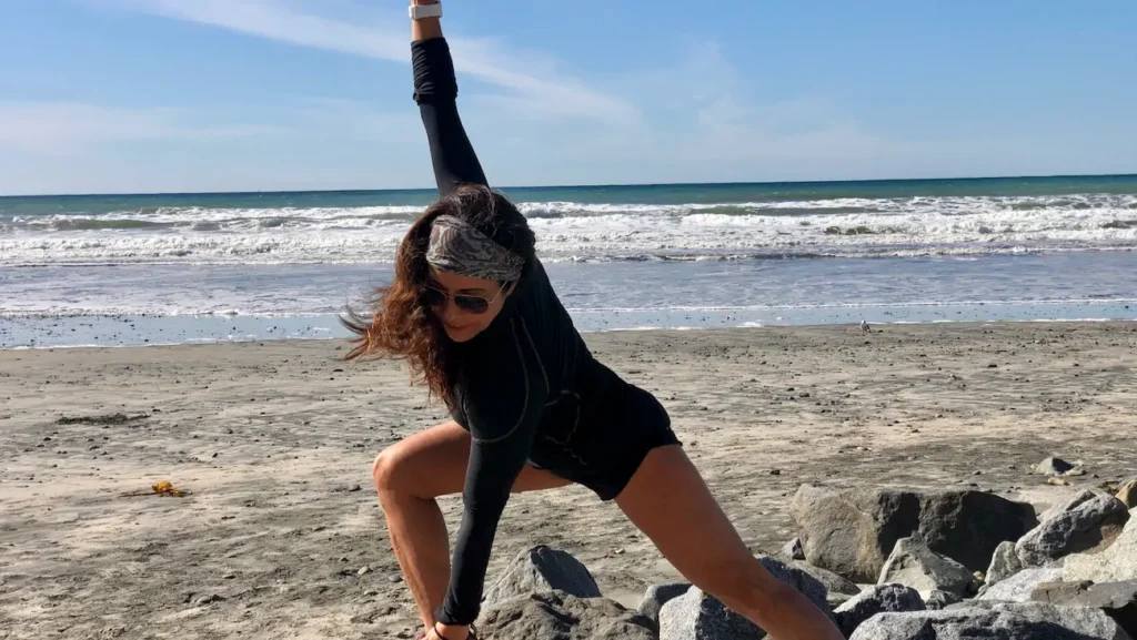 Phoebe Chongchua practicing yoga and movement on the beach