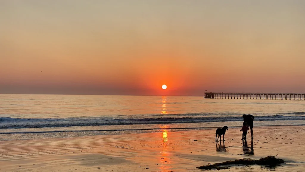 Sunset over Haskell's Beach with Ellwood Pier in Goleta, California.