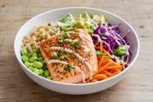 High-protein salmon bowl with edamame, avocado, rice, and vegetables for muscle gain and recovery