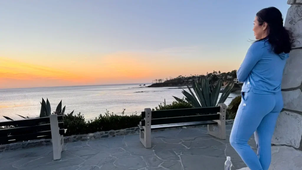 Woman enjoying sunset views overlooking Laguna Beach coastline
