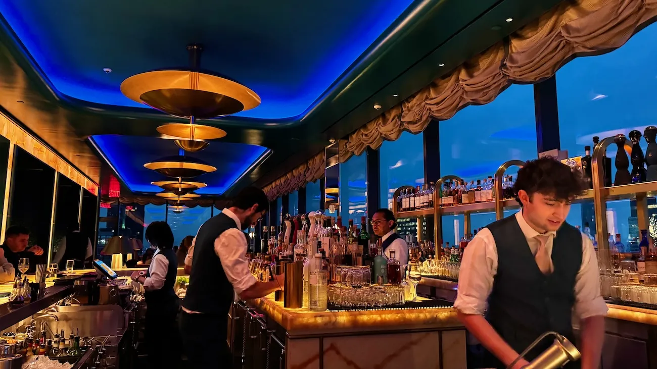 Bartenders preparing drinks inside Nubeluz rooftop bar at The Ritz-Carlton NoMad in New York City
