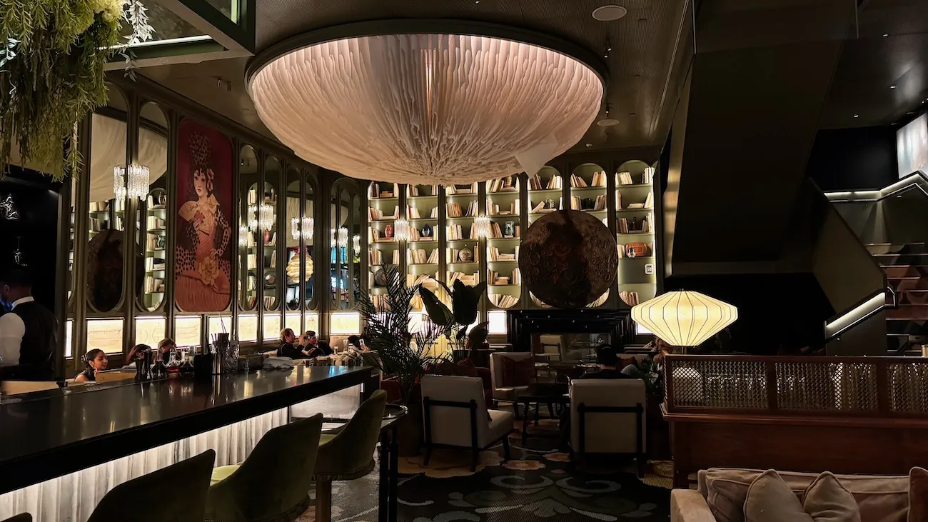 Parlour interior at Bazaar Meats by José Andrés in New York City with sculptural lighting and curated bookshelves