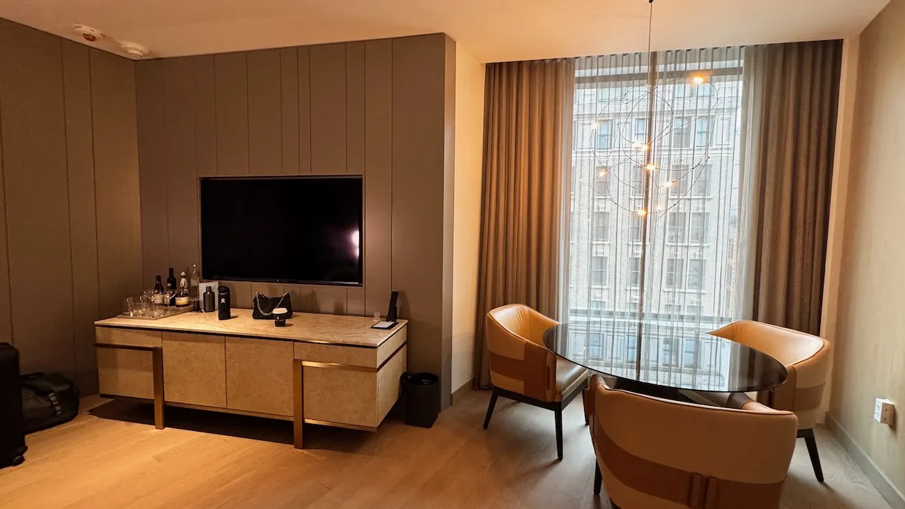 Hotel suite living and dining area with city views at The Ritz-Carlton NoMad in New York City