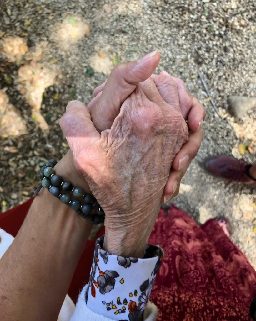 Three generations holding hands while exploring the Santa Barbara Botanic Garden