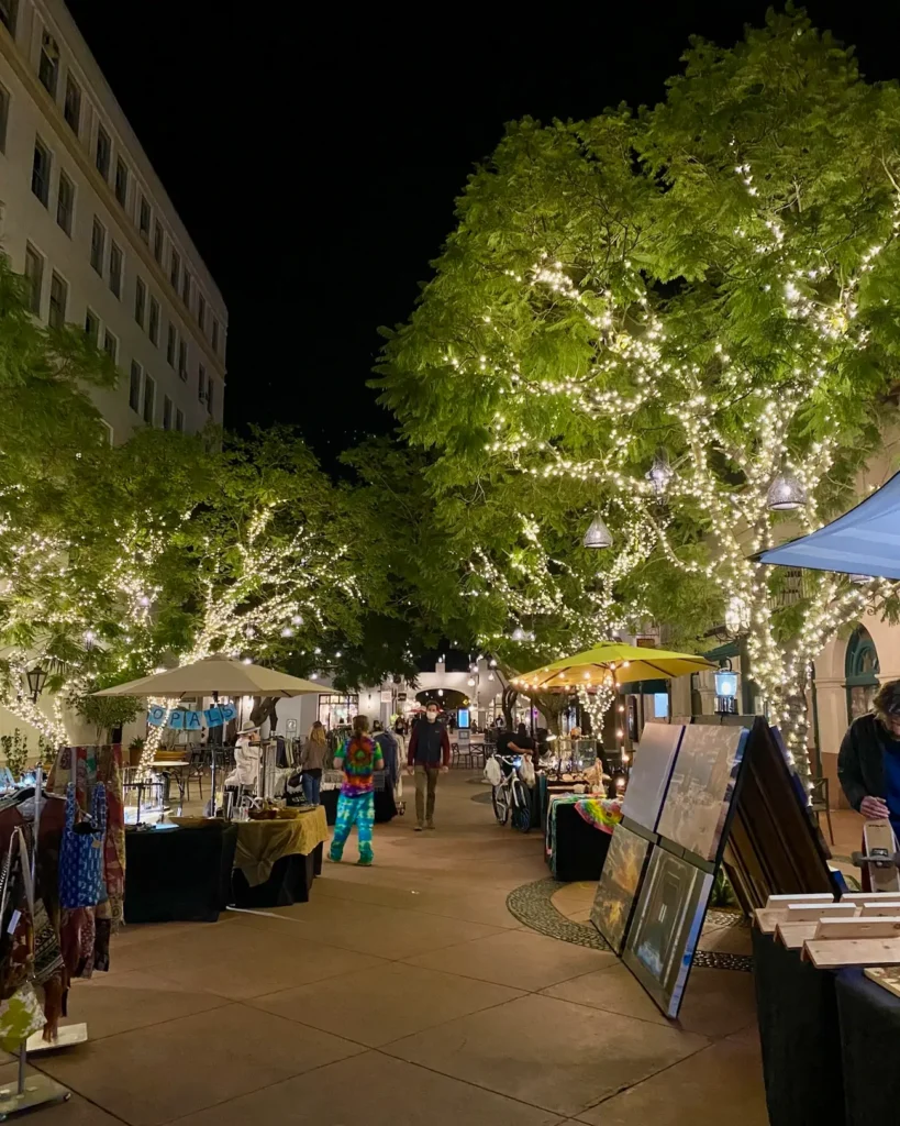 Outdoor dining, local shops, and evening lights along State Street in downtown Santa Barbara, California.