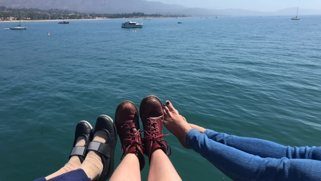 Three generations sitting on Stearns Wharf overlooking the Santa Barbara waterfront