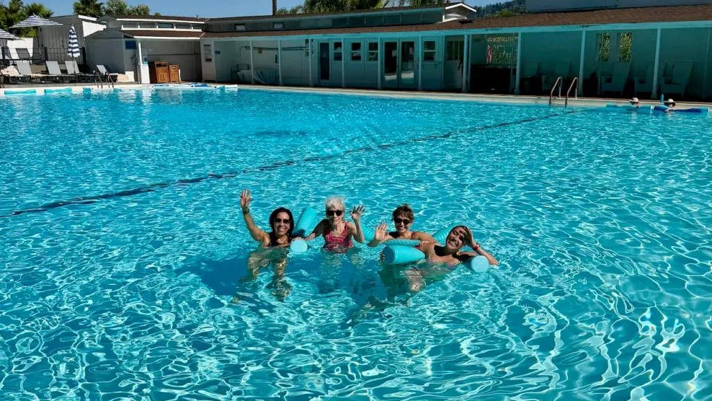 Three generations of family relaxing in the large mineral pool at Indian Springs Calistoga.